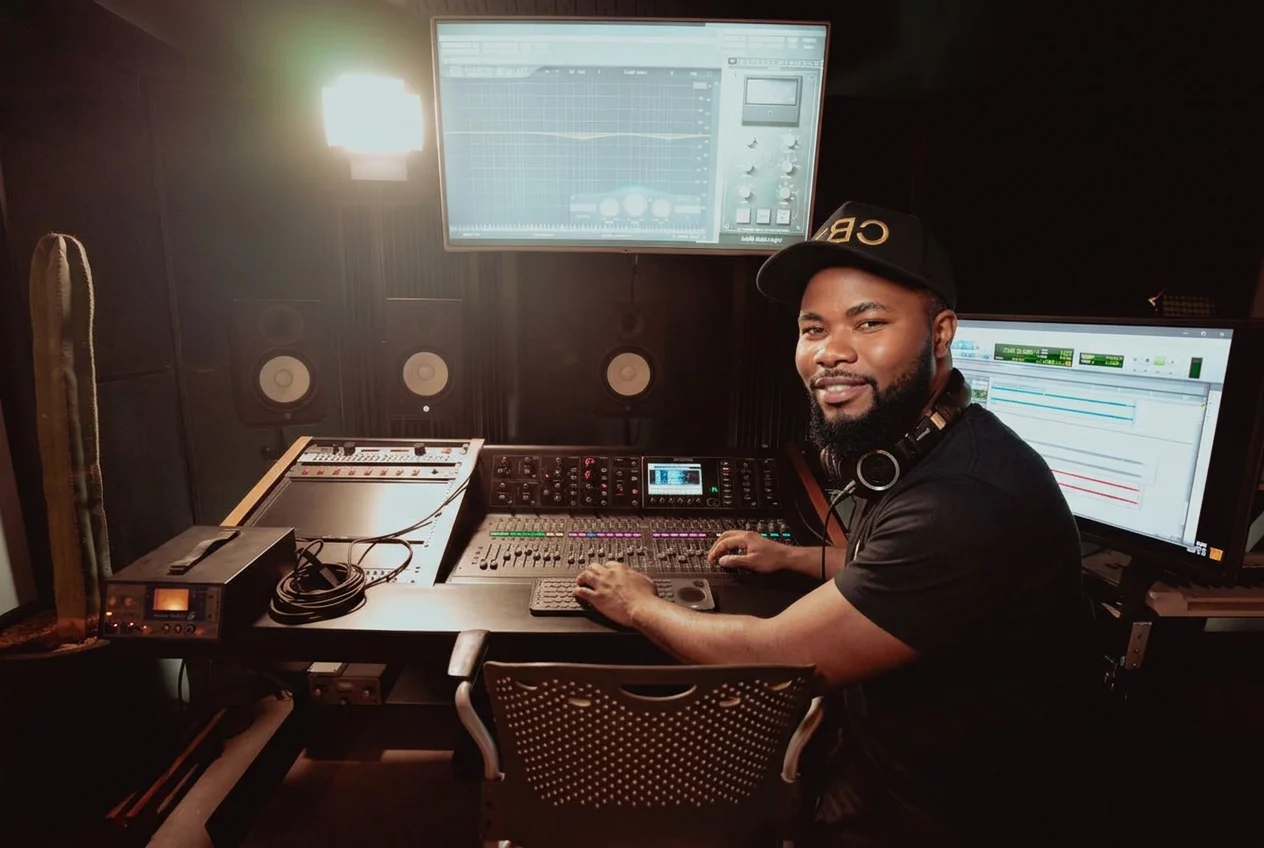 Ephraim Nyadowa producing music at the studio mixing console